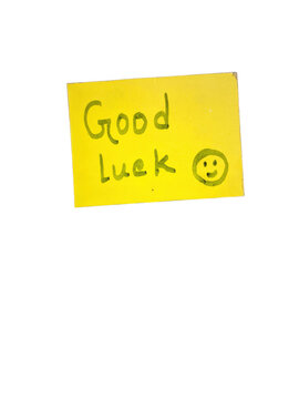 Yellow sticky note with good luck message and smiley face