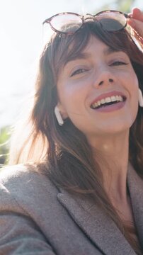 Video of pretty woman taking selfies with smartphone in the park