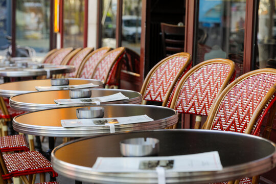 Row of woven bistro chairs outside a Parisian cafe
