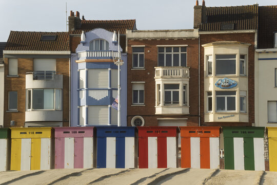 Colorful beach huts in front of historic seaside villas each gable and balcony capturing the bright sky at Malo-Les-Bains beach in Dunkirk, France