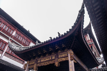 Fototapeta premium Carved eaves and tiled roof at Jade Buddha Temple courtyard, Shanghai, China