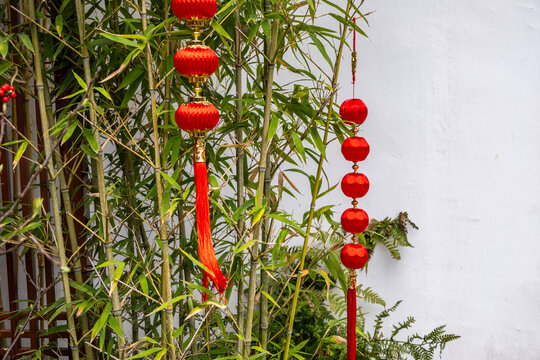 Lanterns and bamboo beside wall at Jade Buddha Temple in Shanghai, China, spring day