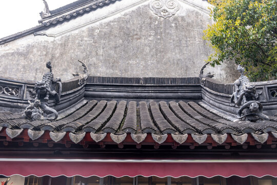 Dragon sculptures on tile eaves with roof detail at Jade Buddha Temple, Shanghai, China
