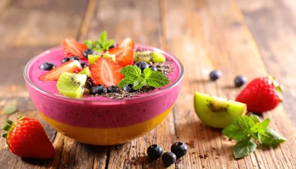 Vibrant Smoothie Bowl Topped with Fresh Fruits and Mint Leaves. © Palas