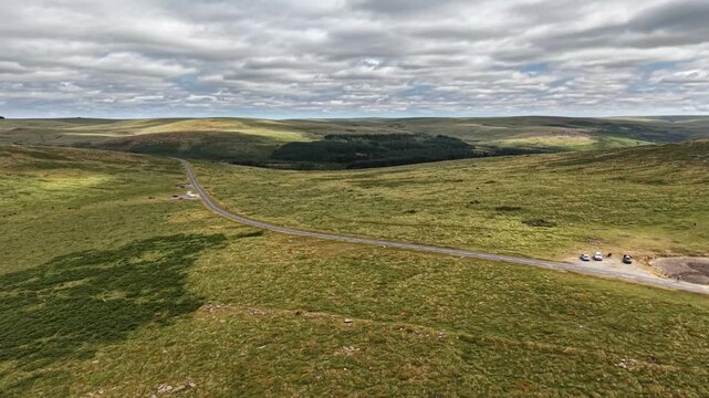 Road through Dartmoor from Princetown passing a dried up pond
