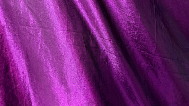 Shiny purple silk fabric texture background elegant dark violet satin drapery folded smooth textile material for luxury fashion design backdrop wedding decoration party banner luxury banner concept.