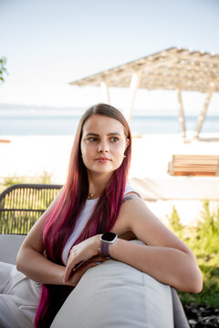 Woman relaxing at outdoor cafe terrace while working remotely