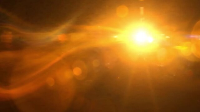 Abstract golden light flare overlay on black background