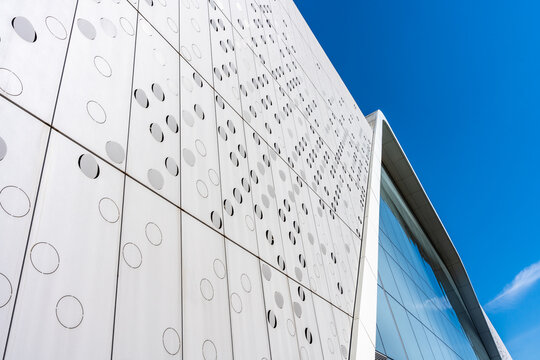 Modern White Building Facade With Geometric Panels And Blue Sky Contemporary Architecture Background