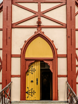 Arched Yellow Wooden Doorway in Half-Timbered church Architecture