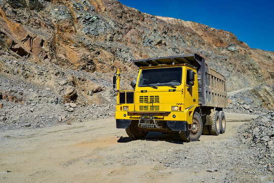Yellow dump truck in open-pit copper mine