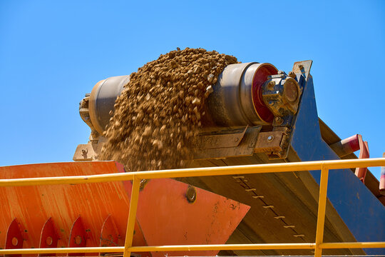 Conveyor in open-pit copper mining with blue sky above