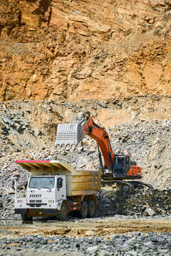 Open-pit copper mining machinery in rugged terrain