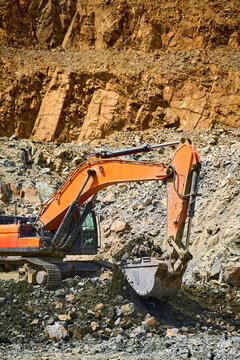Excavator in open-pit copper mine during excavation