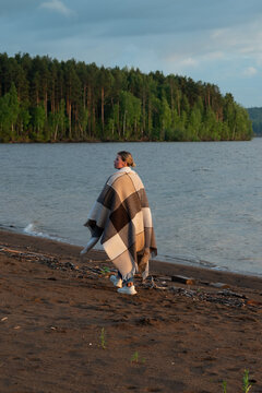 Woman walking by A calm river on quiet forest shore