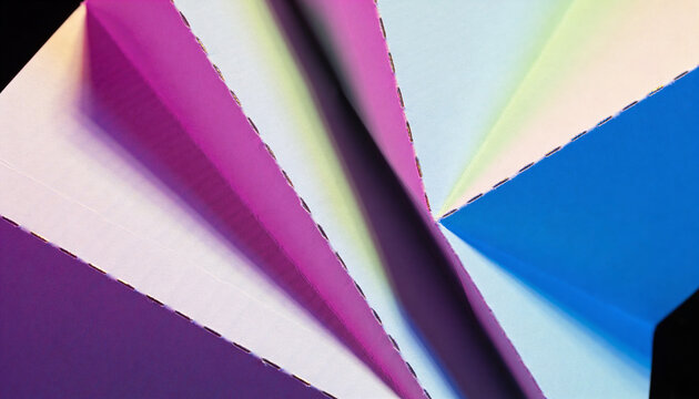 Paper sculpture under vibrant gradient lighting against dark studio backdrop. Sharp edges