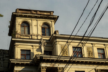 Low angle view of classic vintage building facade with statue and bas-relief details © Cheshire