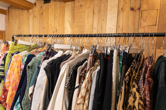 Vibrant women's clothing on a rack in a cozy store