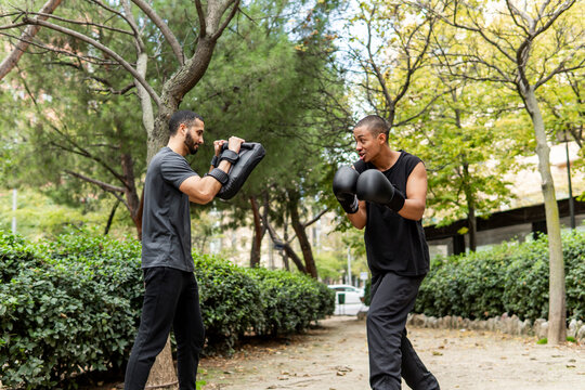 Friends boxing training outdoors