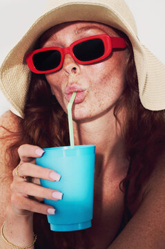 Summer vibes by the pool with sunglasses and drink