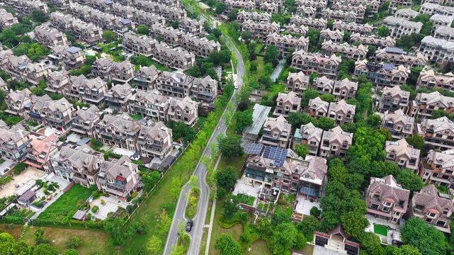 Aerial top-down view of European style villa residential district with winding roads and green trees