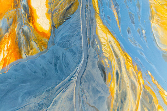 Vibrant abstract landscape texture in blue and gold tones