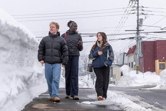 Friends exploring snowy streets in Japan