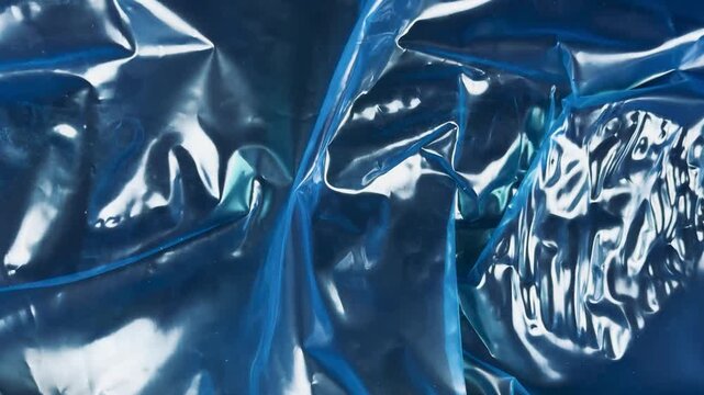 Abstract texture of crumpled blue plastic film