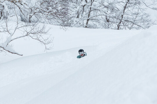 Skier in deep powder snow on Hokkaido backcountry slope