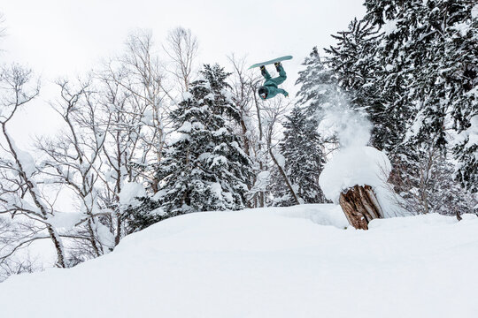 Skier doing backflip in deep powder snow, Hokkaido