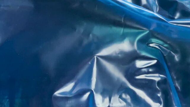Abstract texture of crumpled blue plastic material
