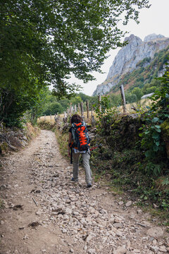Female hiker on rocky mountain trail in Somiedo, Spain