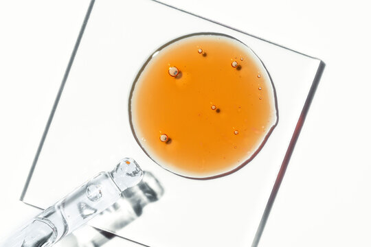 Vitamin C serum oil drop texture with cosmetic bubbles