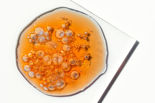 Vitamin C serum oil drop with cosmetic bubble texture