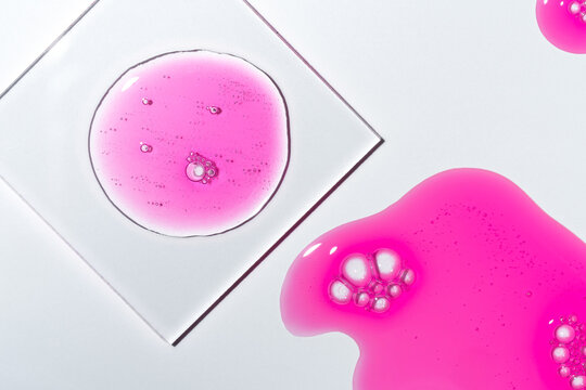 Bright pink gel swatch with smears and smudges macro