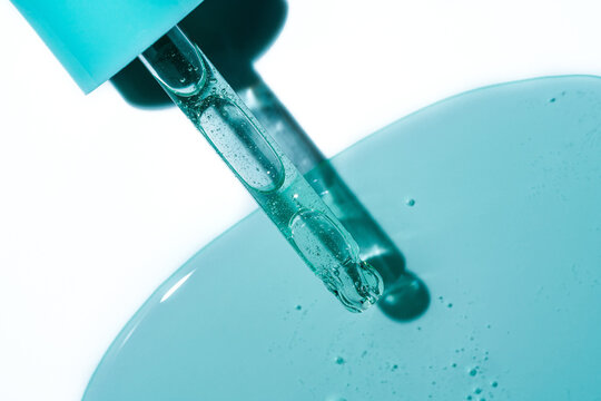 Turquoise gel drop from pipette with smeared swatch