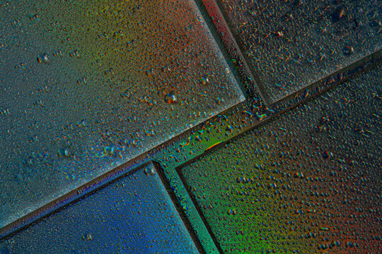 Abstract neon drops on wet glass surface