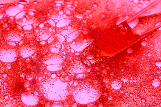 Macro view of serum bubbles with pipette in lab