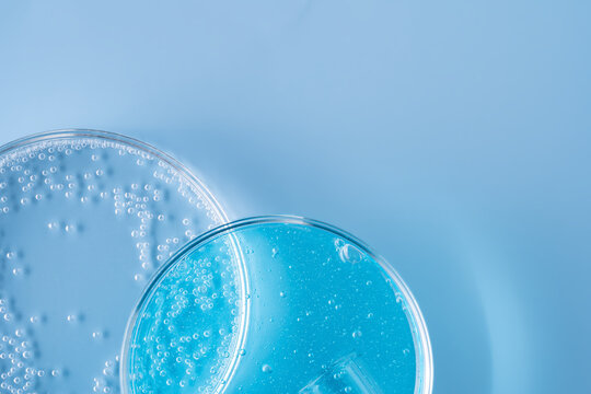 Scientific glassware with blue gel and bubbles background
