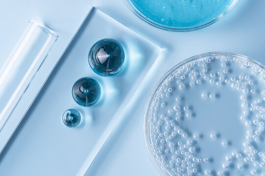 Laboratory glassware with blue gel and liquid droplets