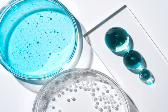 Laboratory glassware with blue gel and clear bubbles flat lay