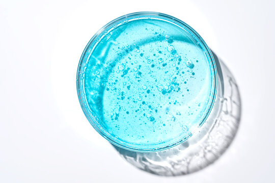 Laboratory glassware with blue solution and bubbles, top view