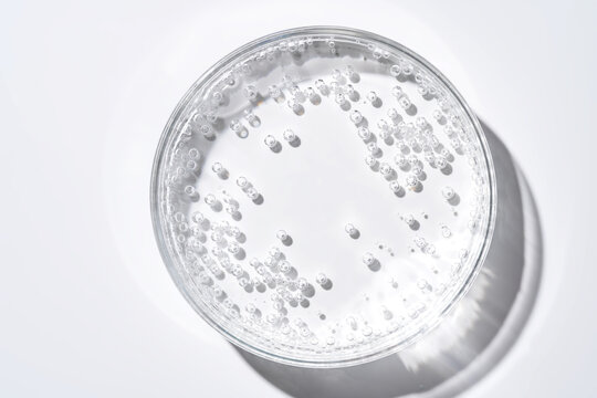 Laboratory glassware with clear liquid and rising bubbles