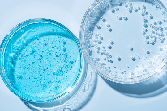 Close-up of laboratory glassware with blue gel and bubbles