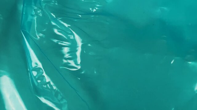 Shiny teal plastic wrap texture background