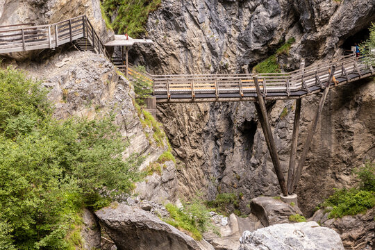 Wooden bridge spanning a rugged gorge landscape