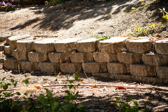 Segmental retaining wall made of interlocking concrete blocks in a garden setting