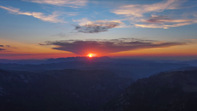 Sun setting over mountain and evening sky