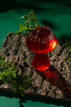 Refreshing blueberry lemonade mocktail in red glass on log
