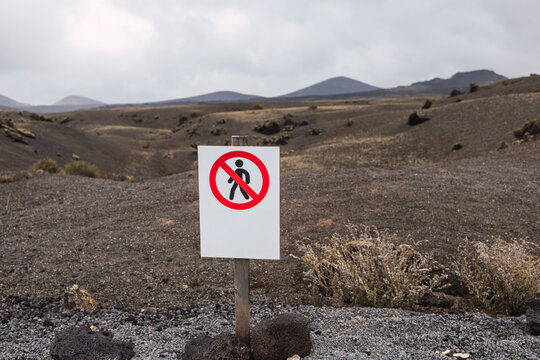 Warning sign in volcanic landscape of Lanzarote